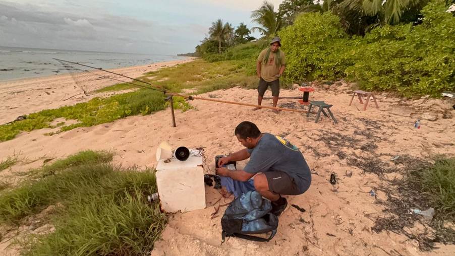 A person working on a machine on the beach.